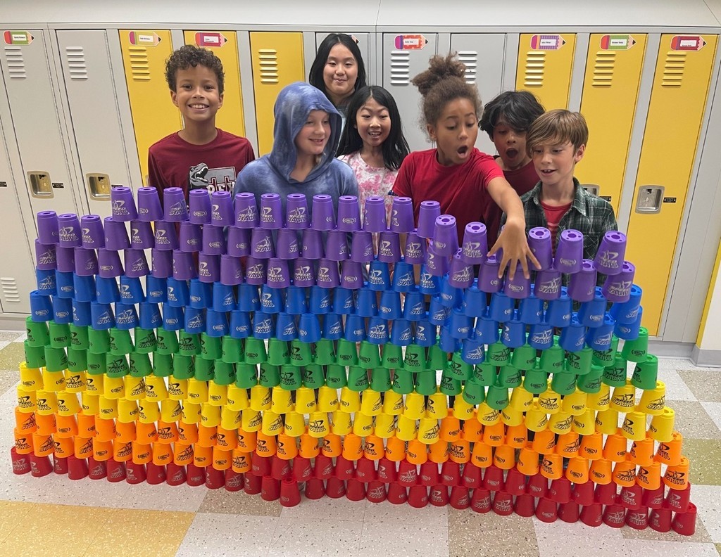 Picture of student's with Stacked row of colorful cupscups