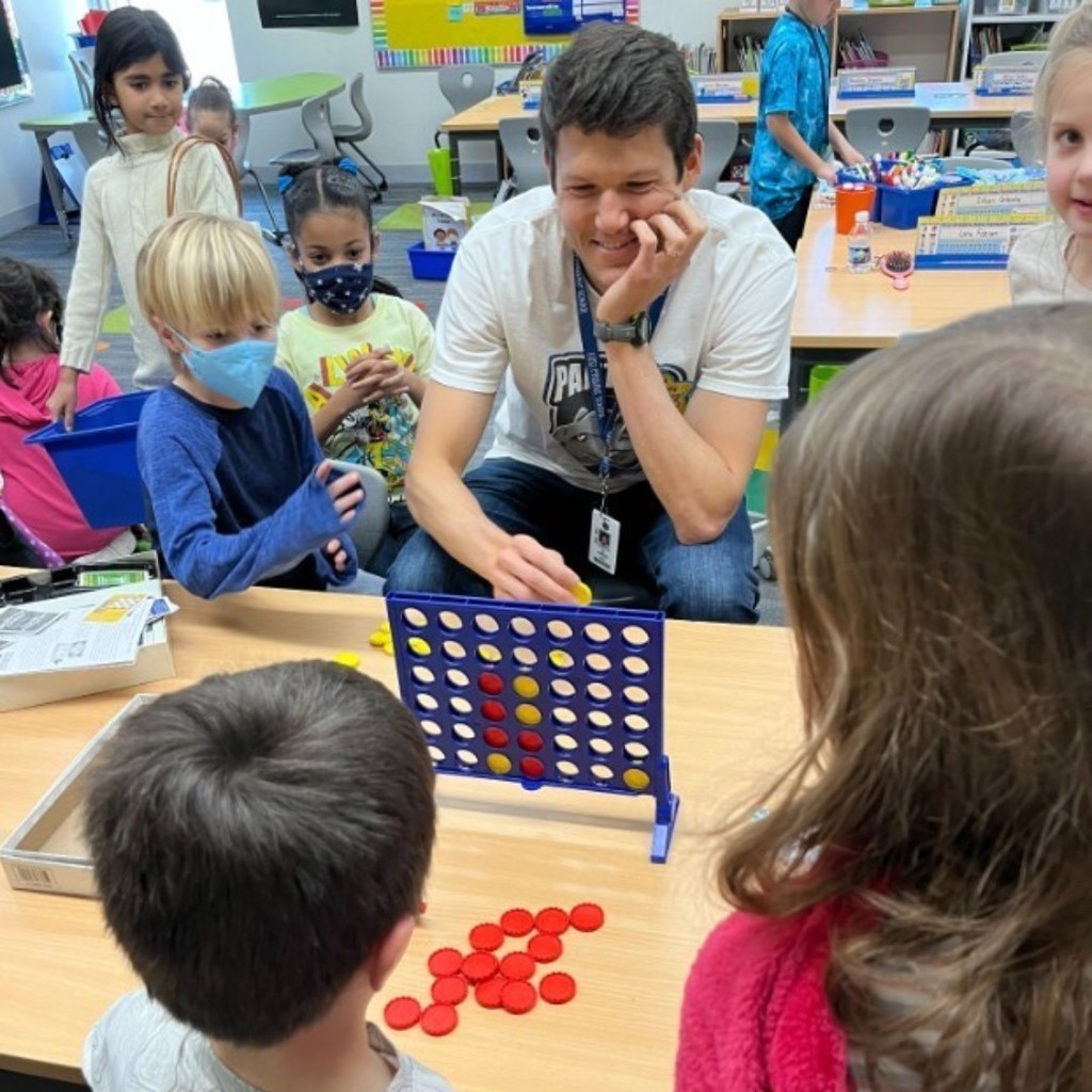 Picture of Principal playing connect 4 with students